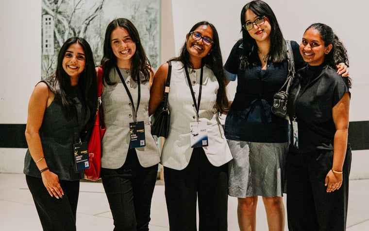 Five ECCEDU students with lanyards in a gallery
